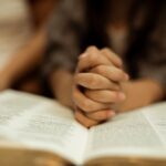 a kid reading the holy bible